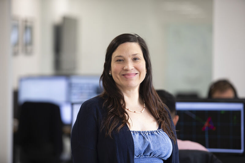 Dr Daniela Benites is in Tadek's office, facing the camera and smiling.