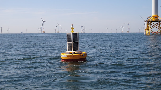 OSIL's Image of a Data Buoy in front of a Wind Farm